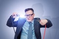 A man in glasses, suit and tie holds two wires with clips in his hands between which an electric discharge occurs Royalty Free Stock Photo