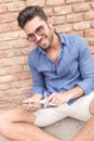 Man with glasses working on his tablet and smiles Royalty Free Stock Photo