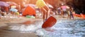 Man glides on surf waves near shore, sandy beach sunset summer Royalty Free Stock Photo