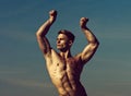Man with glitter on bare chest. Athletic bodybuilder pose as hercules. Gladiator or atlant. Man with muscular wet body.