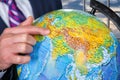 Man with globe beside window. Royalty Free Stock Photo