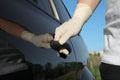 Man in gloves opening car door, closeup view Royalty Free Stock Photo