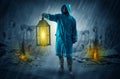 Man with a glowing lantern at a catastrophe scene Royalty Free Stock Photo