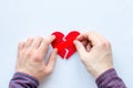 Man glues broken heart on a white background