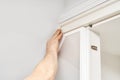 Man gluing wooden molding during wardrobe installation