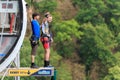 Man with go pro camera on his wrist is about to jump 207 meter bungy at AJ Hackett Sky Park on mountain forest background. Extreme