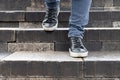 a man goes down the stone steps of an old staircase