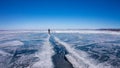 Man goes through a large crack in the ice of Lake Baikal Royalty Free Stock Photo