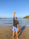 A man goes in for sports, does exercises on the seashore