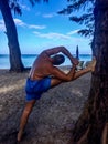 A man goes in for sports, does exercises on the seashore