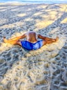 A man goes in for sports, does exercises on the seashore