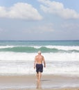 A man goes swimming in dangerous big waves