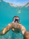 Man in goggles and fins swims under water with his thumb up Royalty Free Stock Photo