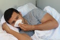 Man going through the flu in bed Royalty Free Stock Photo