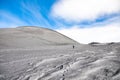 Man going to Escriva crater on volcano Etna in snow in winter, Sicily, Italy Royalty Free Stock Photo