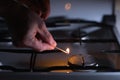 A man going to light a gas stove with a match Royalty Free Stock Photo