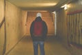 Man going in underpass. Graffiti in subway. Royalty Free Stock Photo