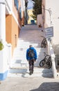 A Man Going Up Sets of Steep Steps in Symi, Greece