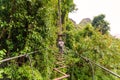 man going on zipline adventure through the forest in Lao