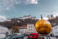 Man on the golden ball statue, modern art titled Sphaera by Stephan Balkenhol at the Kapitelplatz, Salzburg, Austria