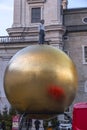 Man on the golden ball statue, modern art titled Sphaera by Stephan Balkenhol at the Kapitelplatz, Salzburg, Austria
