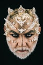 Man with golden reptilian skin and white beard. Monster with sharp thorns and warts on face, horror and fantasy concept