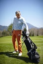 Man with a golf club and bag Royalty Free Stock Photo