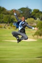 Man, golf and jump for celebration, excited face or portrait for winning, achievement or goal outdoor. African Royalty Free Stock Photo