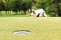 Man golfer check line for putting golf ball on green grass Royalty Free Stock Photo