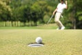 Man golfer cheering after a golf ball on a golf green Royalty Free Stock Photo