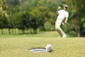 Man golfer cheering after a golf ball on a golf green Royalty Free Stock Photo