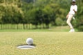 Man golfer cheering after a golf ball on green Royalty Free Stock Photo