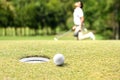 Man golfer cheering after a golf ball on a golf green Royalty Free Stock Photo