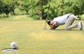 Man golfer cheering after a golf ball on a golf green Royalty Free Stock Photo