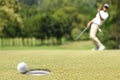 Man golfer cheering after a golf ball on green Royalty Free Stock Photo