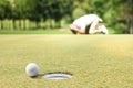 Man golfer feeling disappointed after a putted golf ball missed the hole Royalty Free Stock Photo