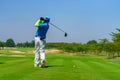 Man Golfer Hitting Ball with Club on Beatuiful Golf Course Royalty Free Stock Photo