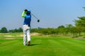 Man Golfer Hitting Ball with Club on Beatuiful Golf Course Royalty Free Stock Photo