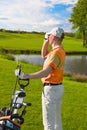 Man golfer watching into rangefinder