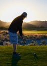 Man golfing as twilight approaches