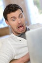 Man got scared in front of tablet Royalty Free Stock Photo