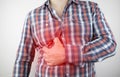 A man grabs his right side under the ribs. Pain in the liver. Pain syndrome in liver disease