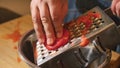 A man grates tomatoes to make a sauce. Royalty Free Stock Photo