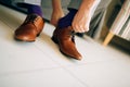 The man in gray slacks and a purple dress socks brown shoes with Royalty Free Stock Photo