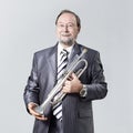 Man in a gray suit with a trumpet Royalty Free Stock Photo