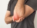 Man holds a painful elbow Royalty Free Stock Photo