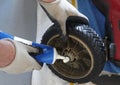 Man Greasing Lawn Mower Wheel Royalty Free Stock Photo