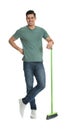 Man with green broom on white background