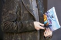 Man with green floral coat and smartphone before Etro fashion show, Milan Fashion Week street style on January