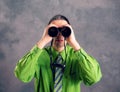 Man in green shirt and necktie looking through a binoculars Royalty Free Stock Photo